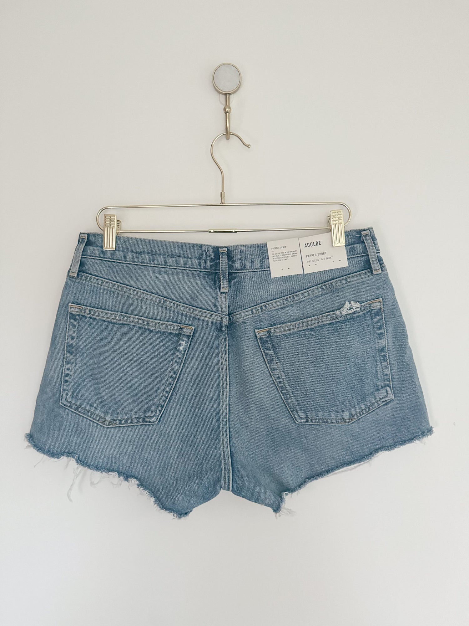 the back of a pair of women's Agolde Parker denim cutoff shorts