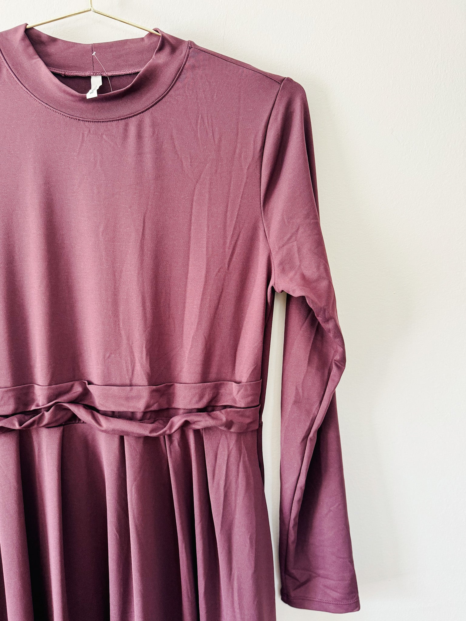 Purple Halara dress with long sleeves on a white background