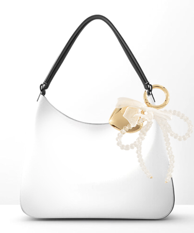 White handbag with a black handle and gold clasp on a white background