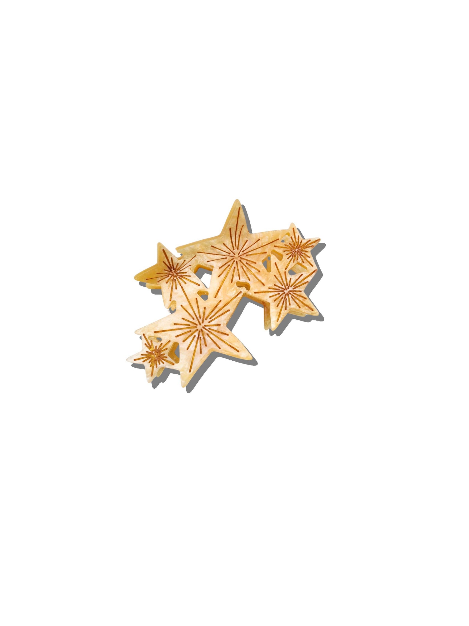 Gold stars hair clip on a white background