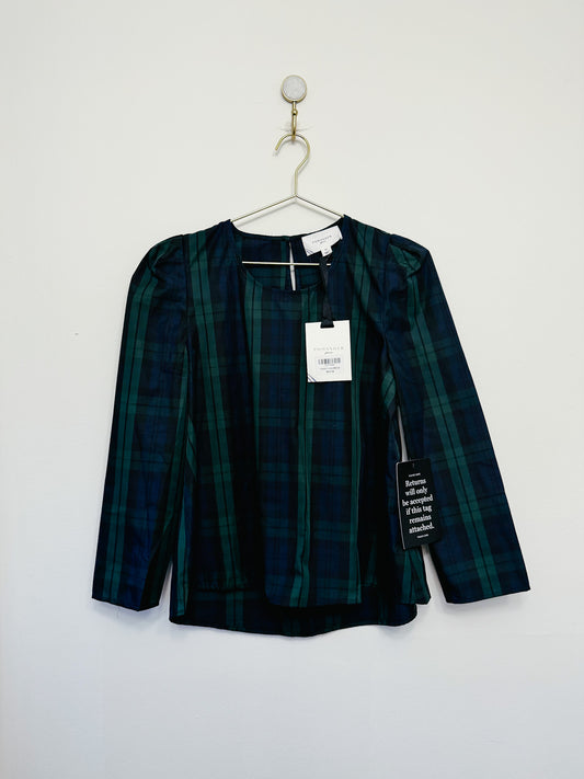 Green plaid shirt on a hanger against a white background