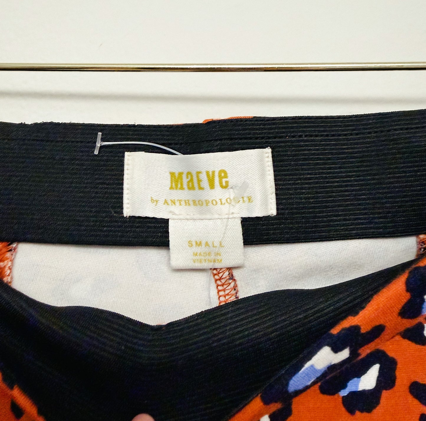 Close-up of a label on a garment with 'MAEVE' branding.