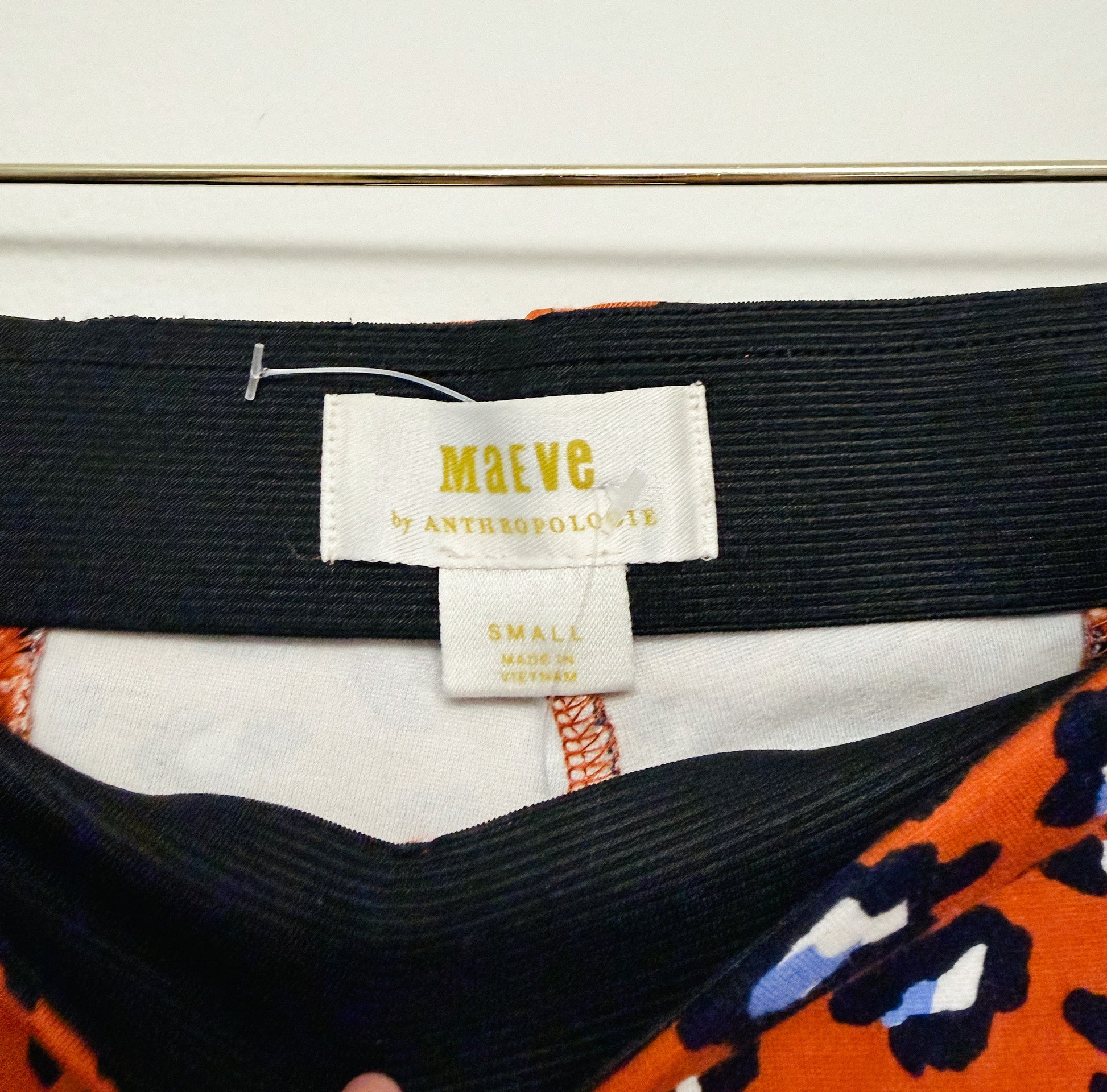 Close-up of a label on a garment with 'MAEVE' branding.