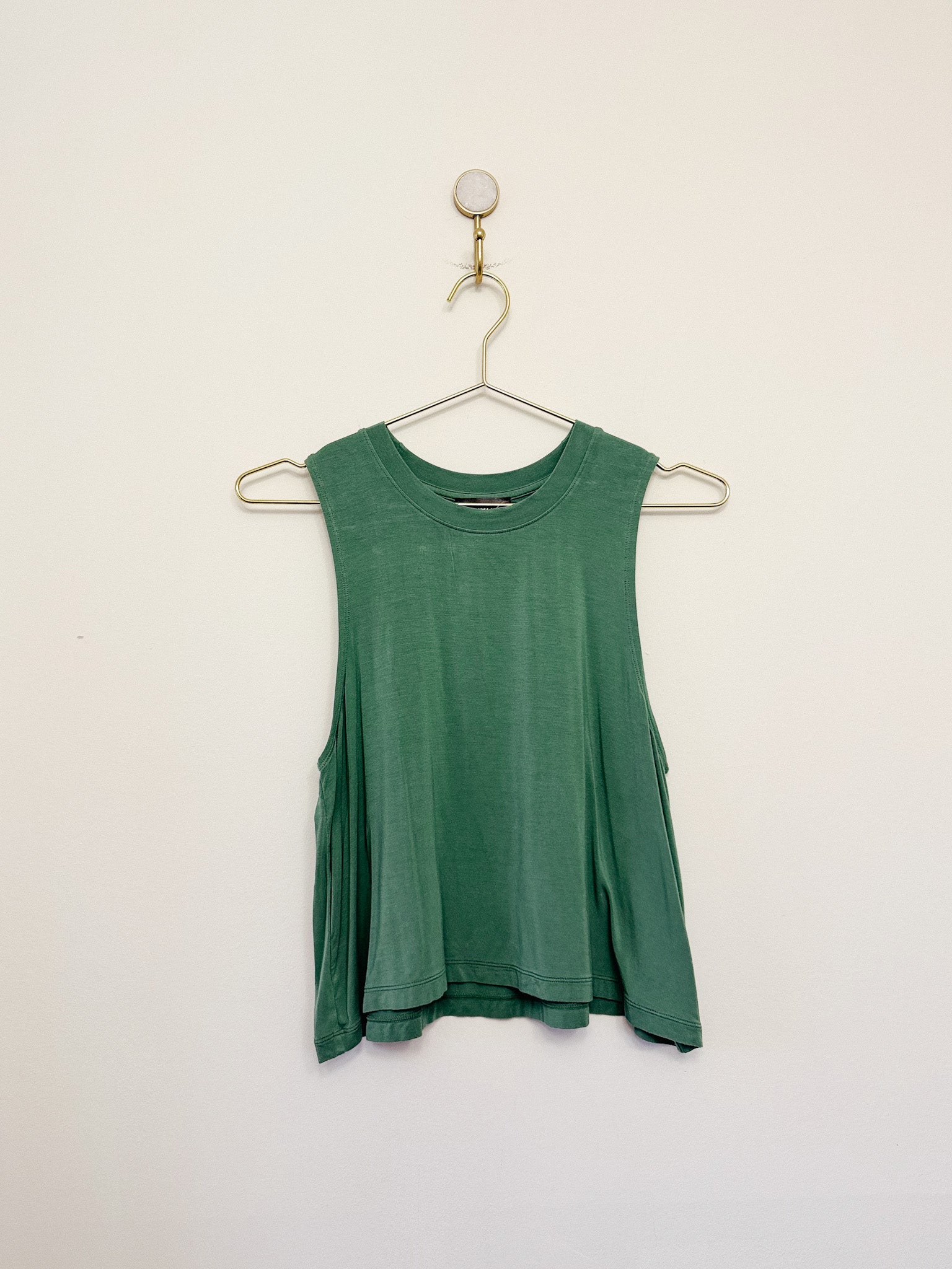 Carbon38 Crop Tank 2.0 tank top on a hanger against a white background