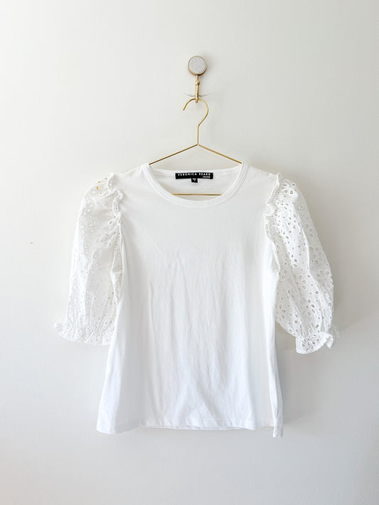 White Veronica Beard Jeans tee with eyelet sleeves on a hanger against a white background