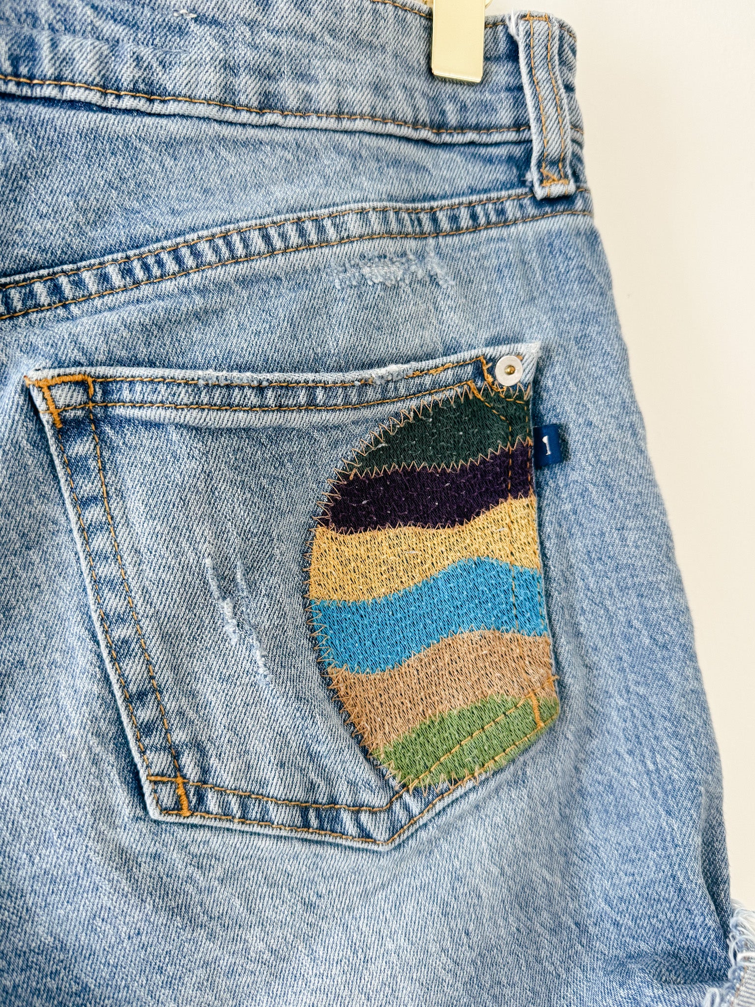 Pilcro by Anthropologie Patchwork Signature Shorts back pocket embroidery details