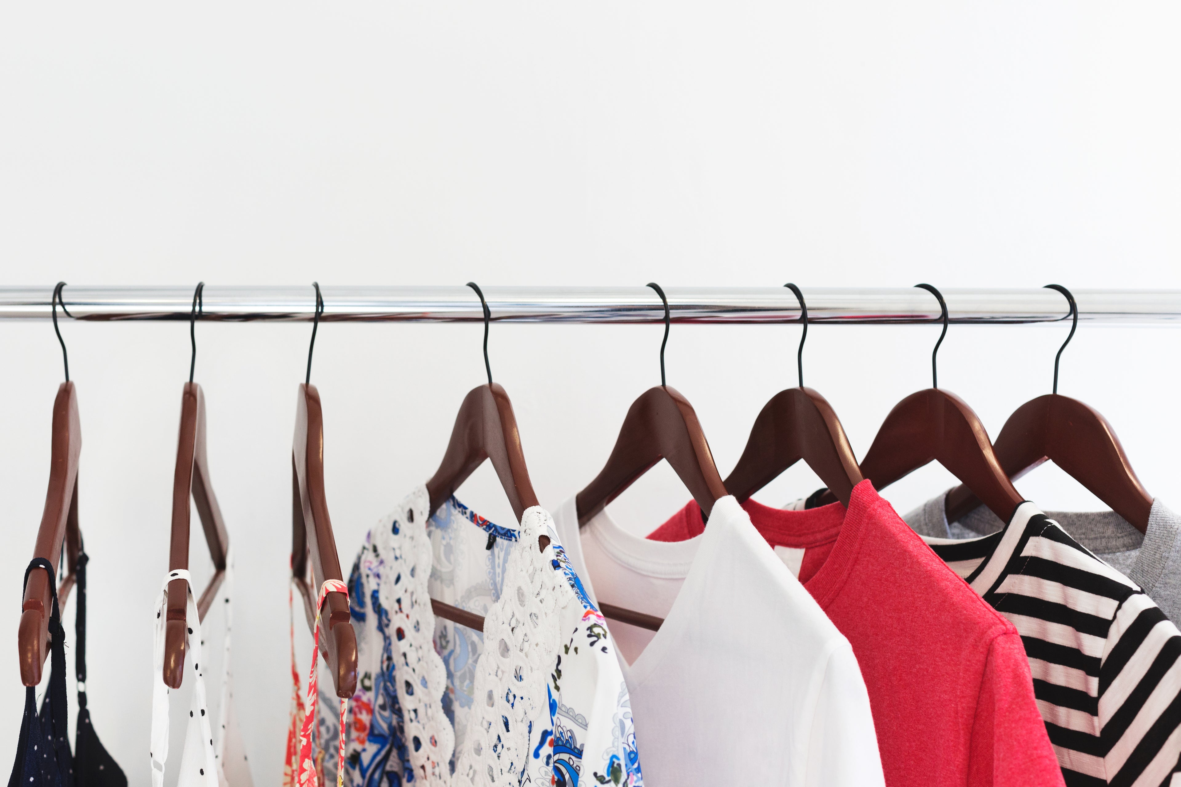 curated selection of women's clothing on wooden hangers