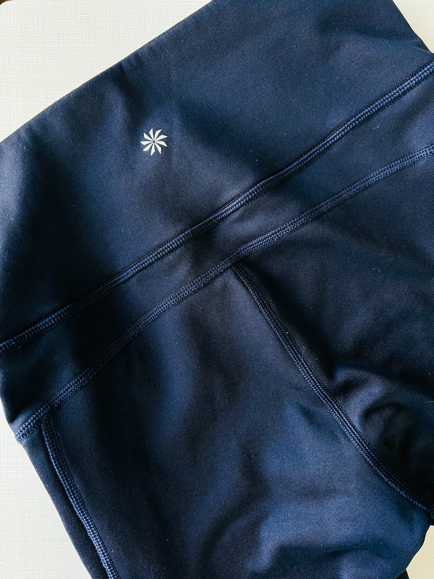 upper back of athleta fleece lined navy blue winter athletic tights. 