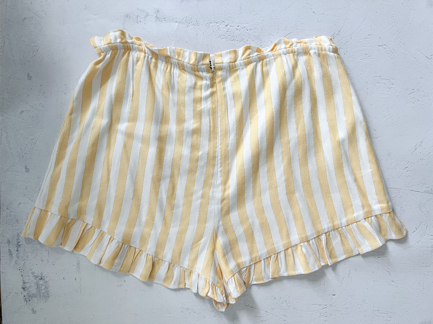 closer shot of back - lovers and friends yellow and white striped shorts